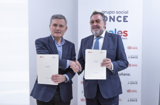 Foto de los firmantes saludándose y mostrando el convenio