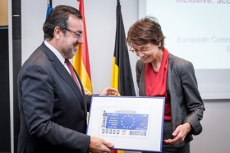 Foto de Miguel Carballera entregando una réplica del Cupón de la UE a la comisaria